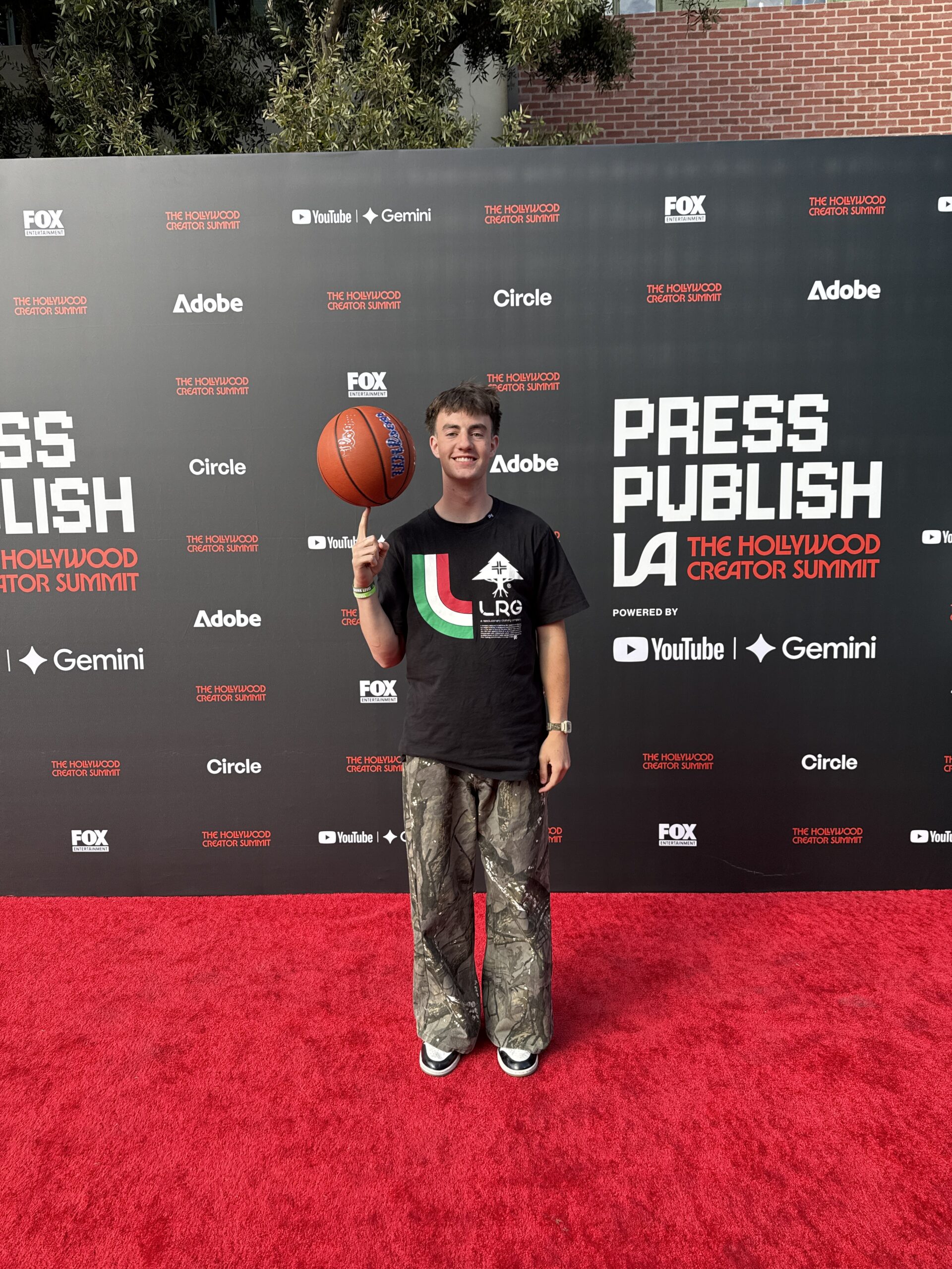 McDeezy spinning a basketball on the Press Publish LA red carpet